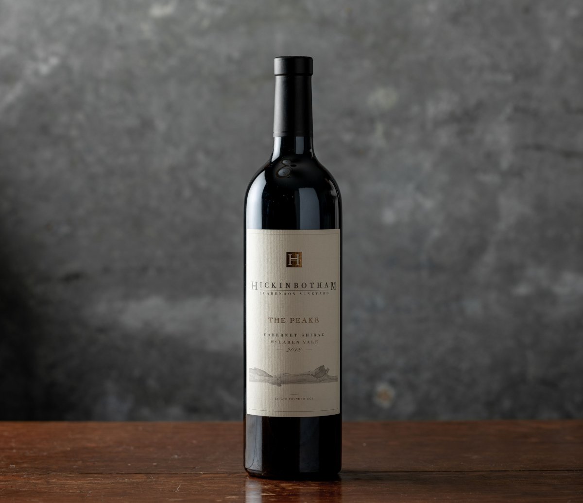 Single bottle of 2018 Hickinbotham The Peake Cabernet Shiraz against a dark background